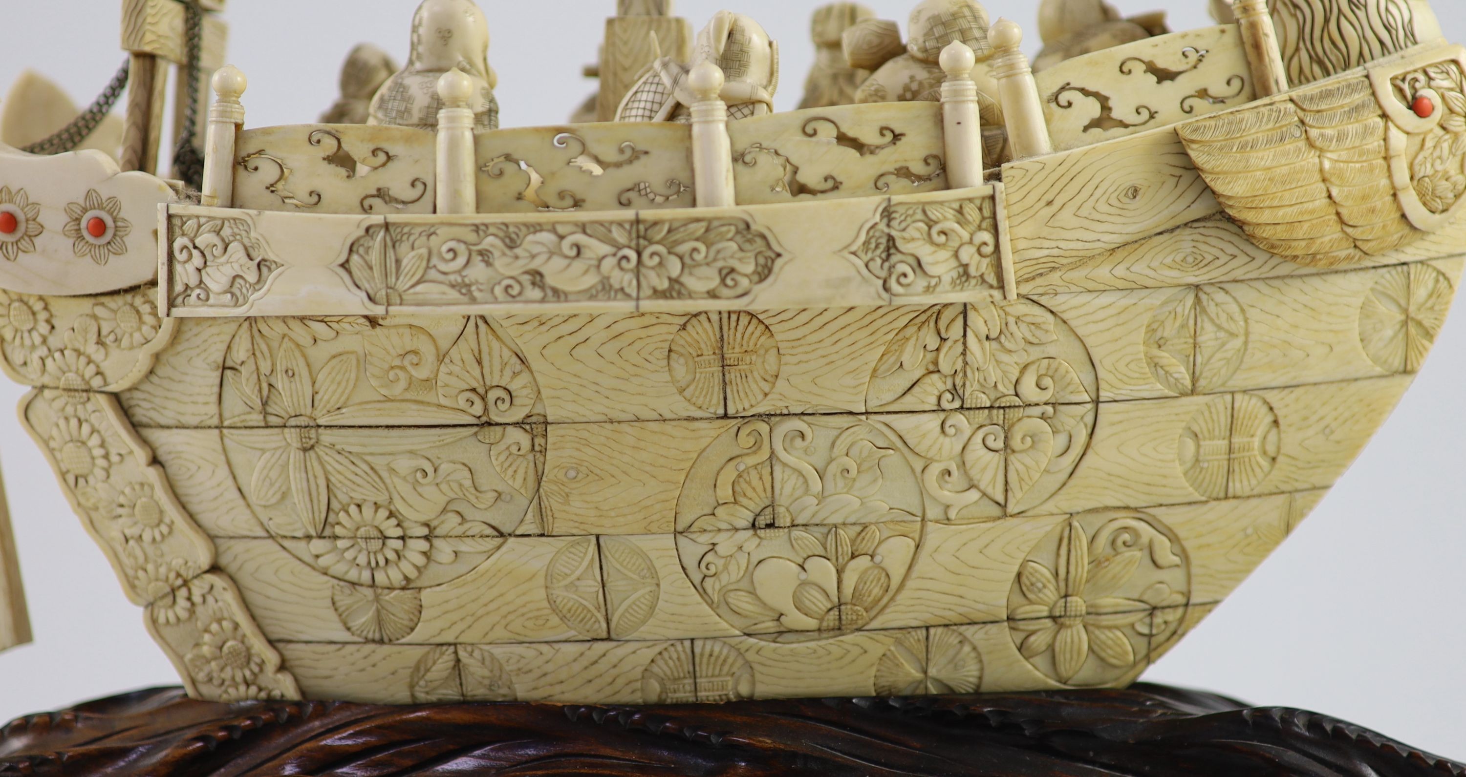A large Japanese ivory okimono of the seven Gods of Happiness treasure ship the Takarabune, early Showa period, Total height 42 cm, length 41 cm, slight faults